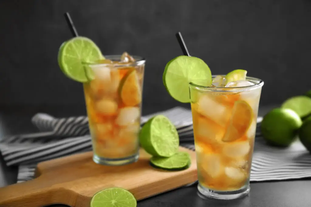 Glasses of iced tea with lime slices on table